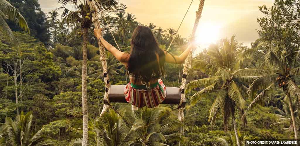 Swinging from a rope swing in Bali